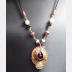 Copper forged fold form mixed metal cocoon pendant with beads