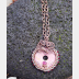 Bold and sassy rhodonite mixed metal donut pendant