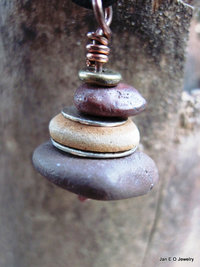 Om stacked beach rock cairn in brown tones Pacific NW beach stones