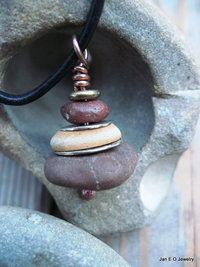 Om stacked beach rock cairn in brown tones Pacific NW beach stones