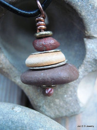 Om stacked beach rock cairn in brown tones Pacific NW beach stones