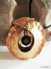 Tribal fold form bronze and iron pyrite healing cocoon pendant