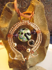 Mixed metal sterling and copper wire woven lampwork organic swirling pendant