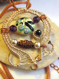 Mixed metal sterling and copper wire woven lampwork organic swirling pendant