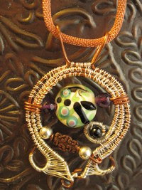 Mixed metal sterling and copper wire woven lampwork organic swirling pendant