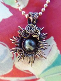 Copper corona pendant with multicolored stone center