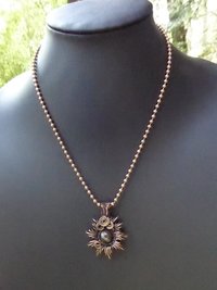 Copper corona pendant with multicolored stone center