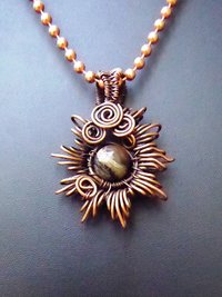 Copper corona pendant with multicolored stone center