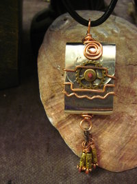 Zen prayer pendant of mixed metals with word wisdom inside