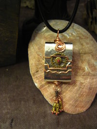 Zen prayer pendant of mixed metals with word wisdom inside