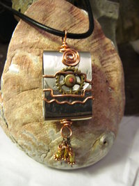 Zen prayer pendant of mixed metals with word wisdom inside