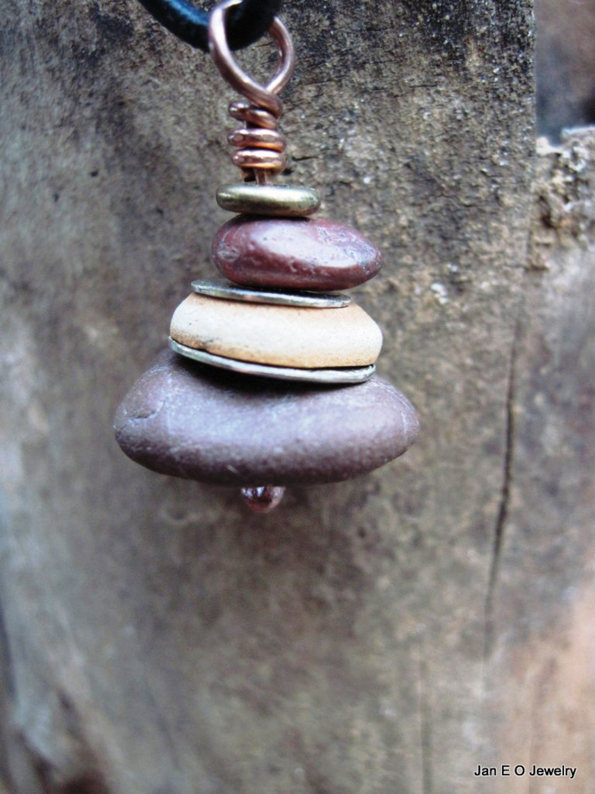 Om stacked beach rock cairn in brown tones Pacific NW beach stones