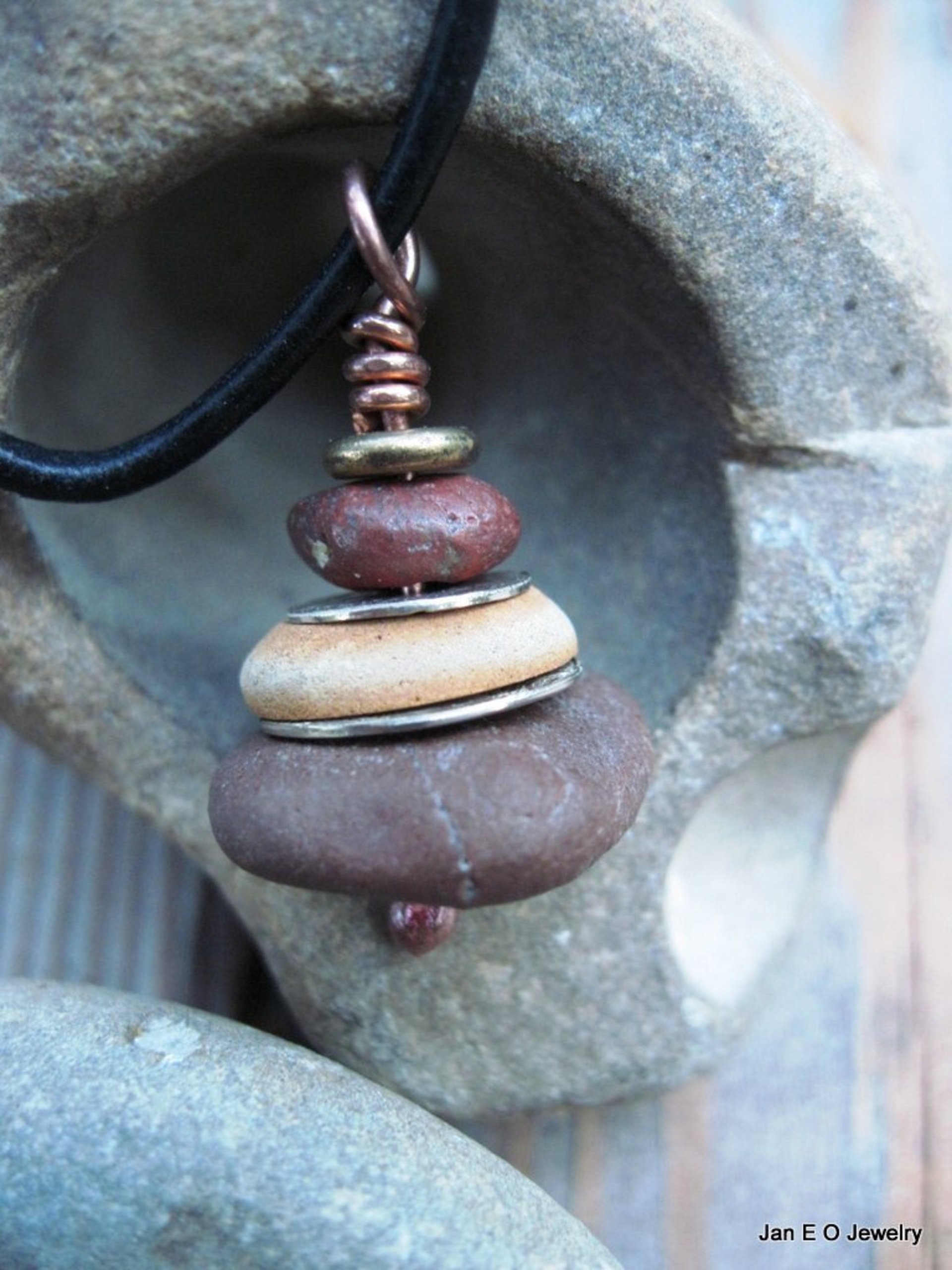 Om stacked beach rock cairn in brown tones Pacific NW beach stones