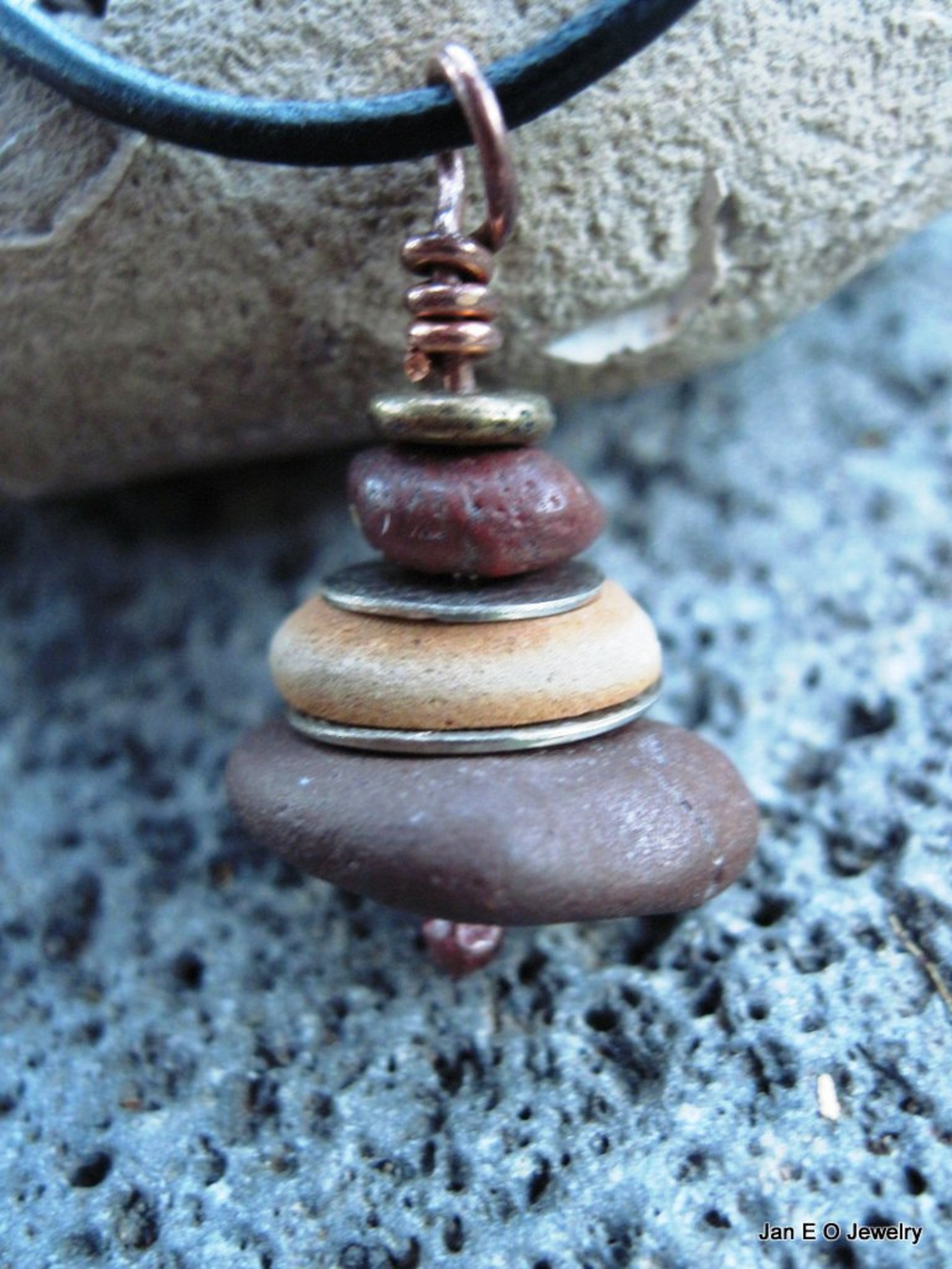Om stacked beach rock cairn in brown tones Pacific NW beach stones