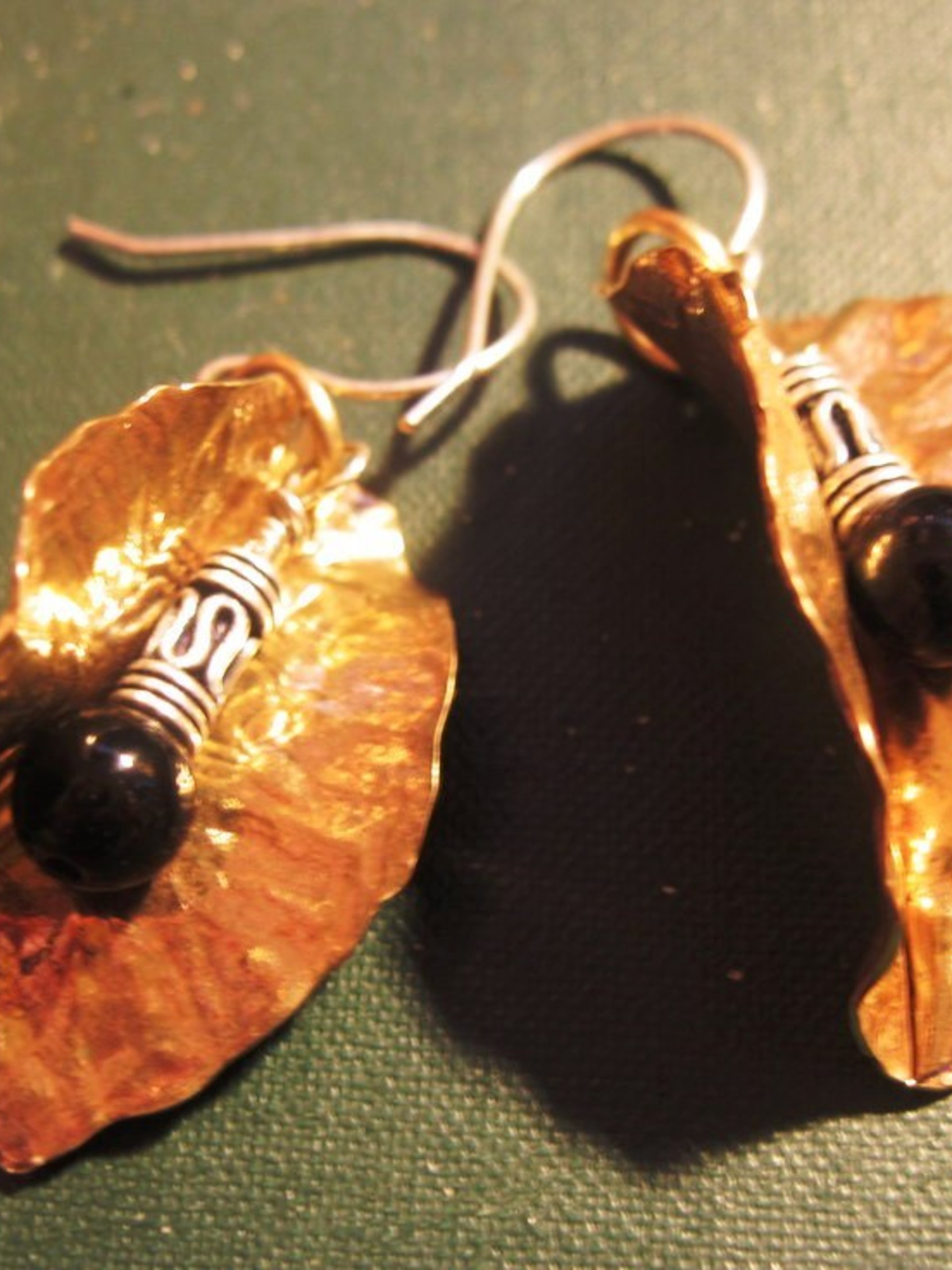 Tribal fold form bronze leaf earrings with sterling and black onyx