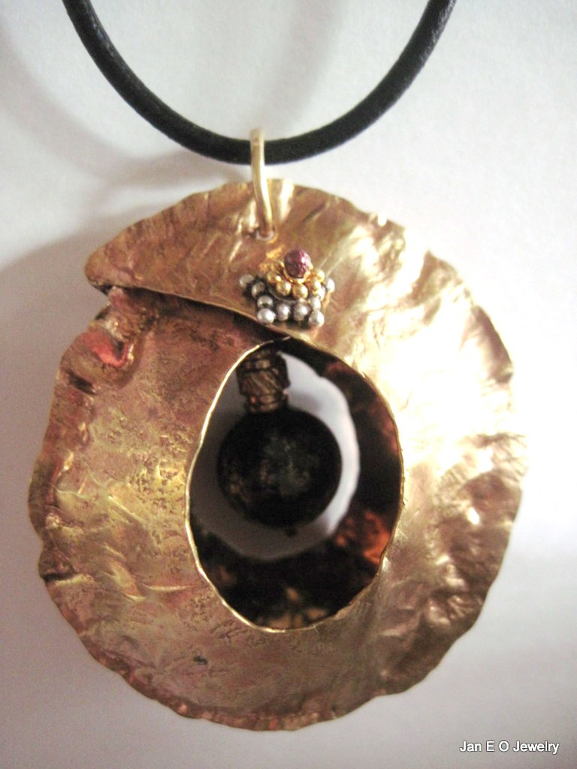 Tribal fold form bronze and iron pyrite healing cocoon pendant
