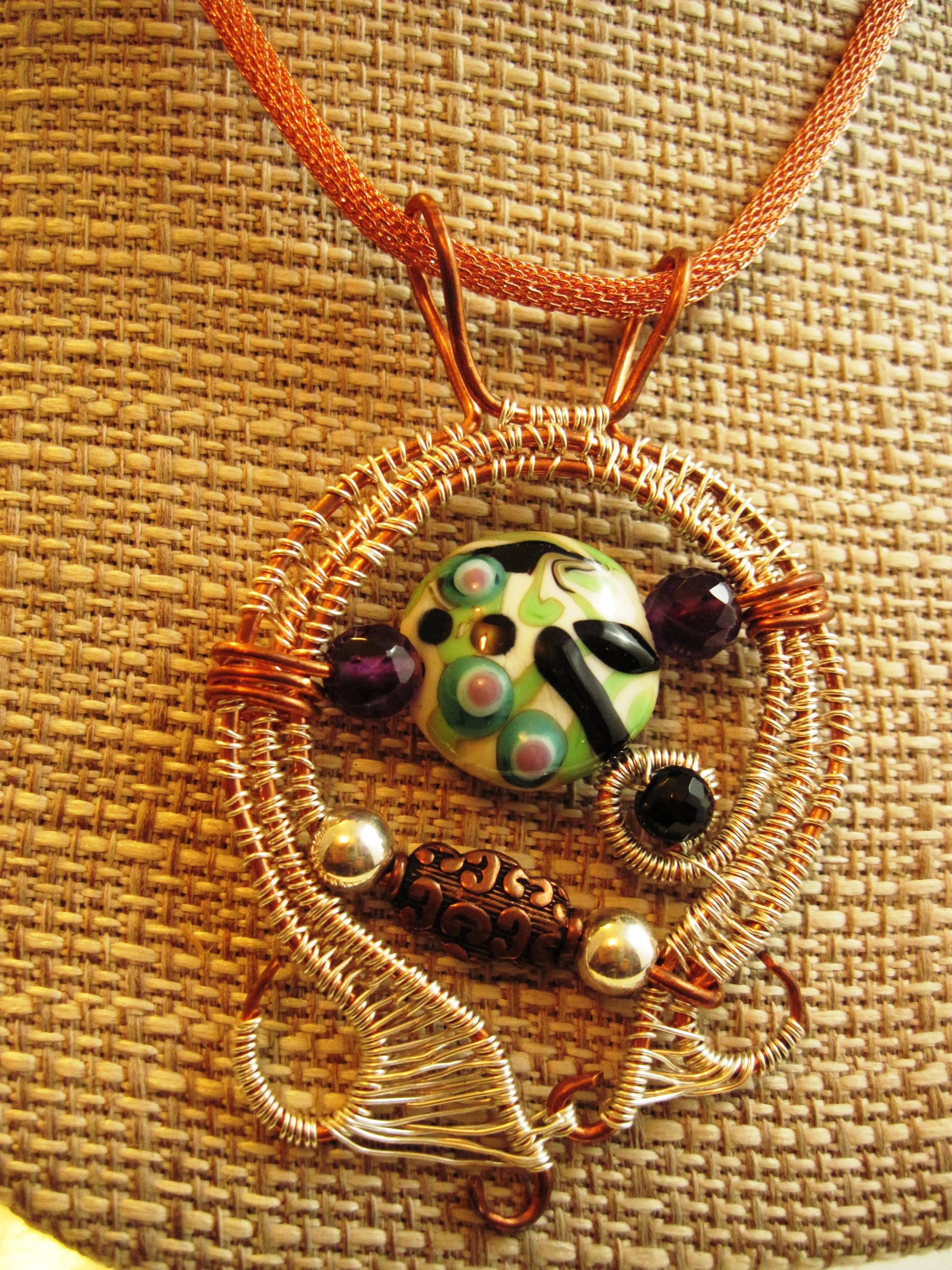 Mixed metal sterling and copper wire woven lampwork organic swirling pendant