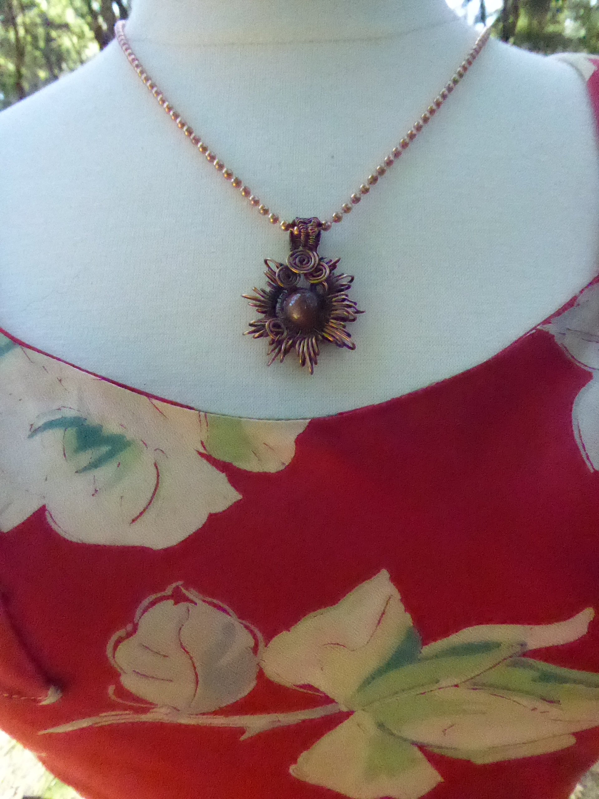 Copper corona pendant with multicolored stone center
