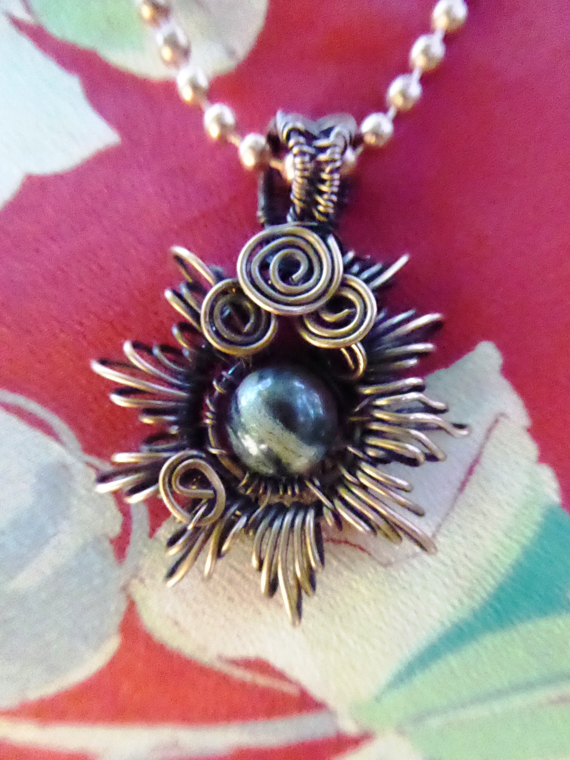 Copper corona pendant with multicolored stone center
