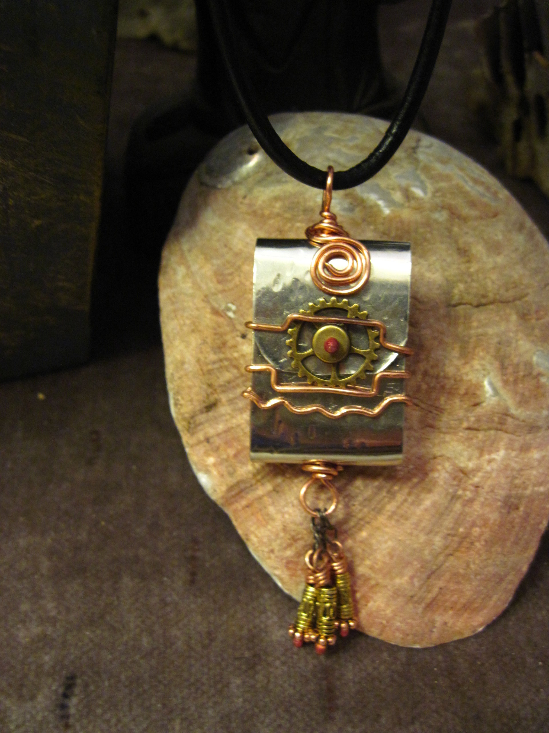 Zen prayer pendant of mixed metals with word wisdom inside