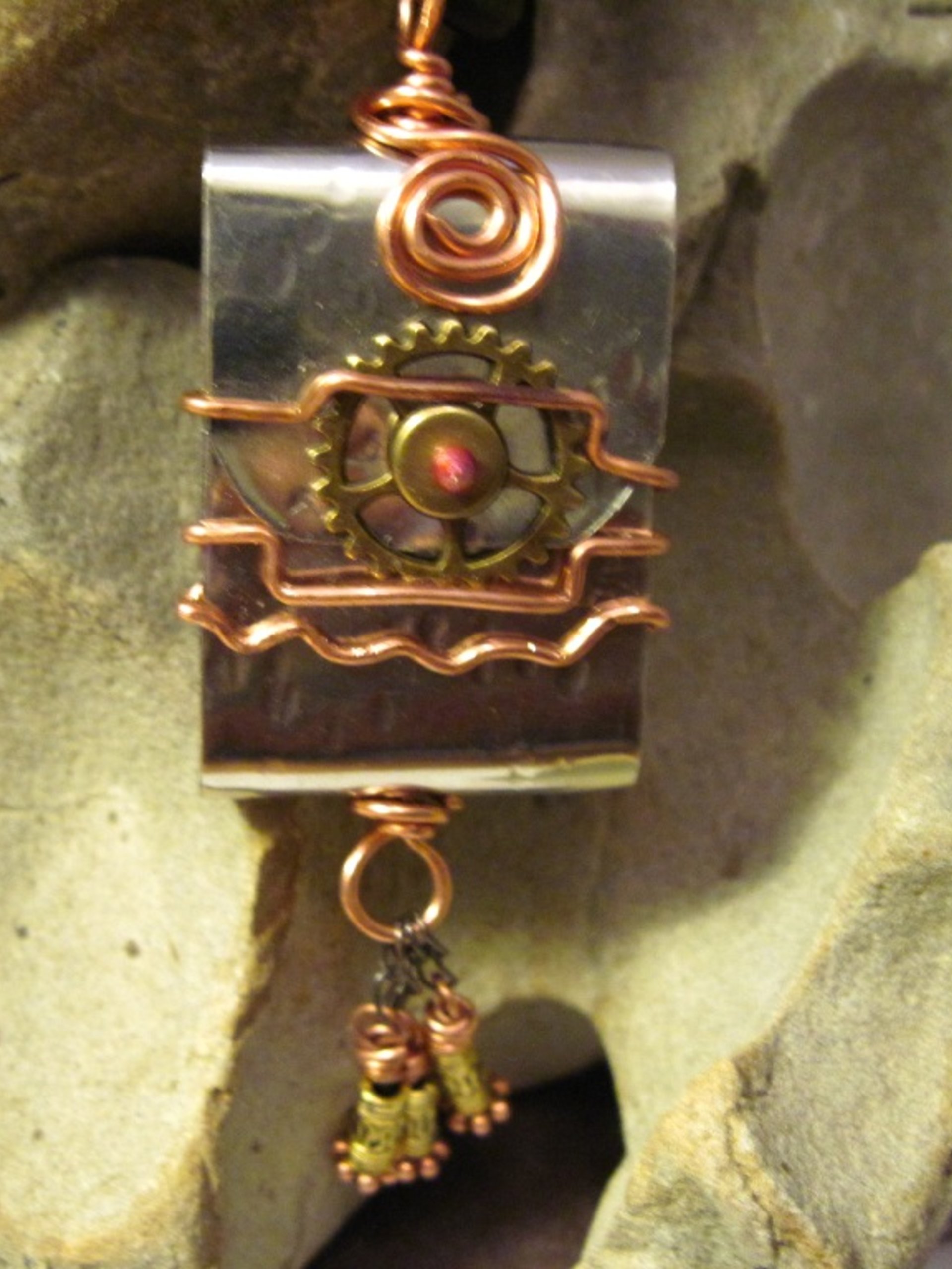 Zen prayer pendant of mixed metals with word wisdom inside