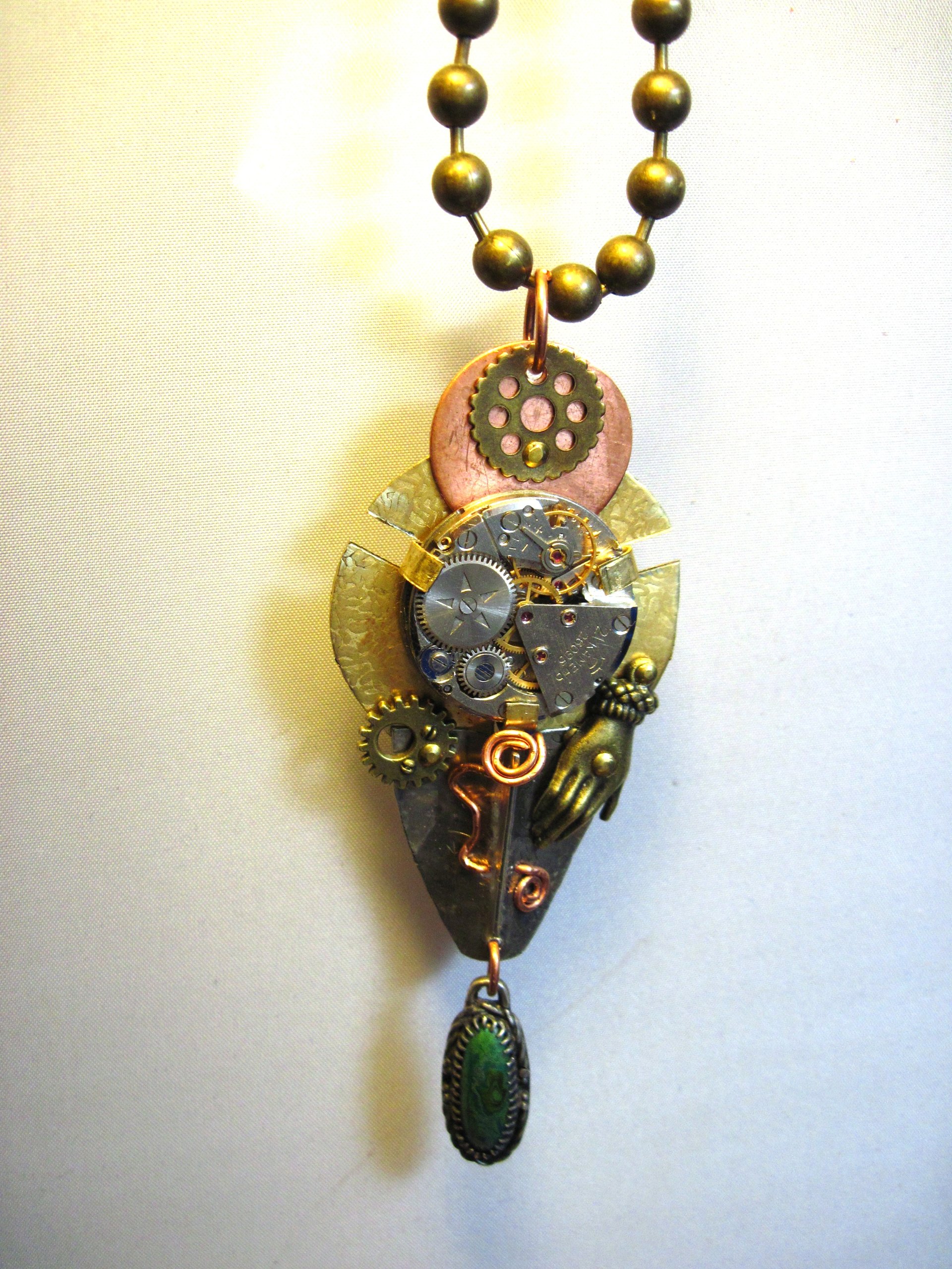 Steampunk mixed metal watchwork gear pendant called Full Steam Ahead