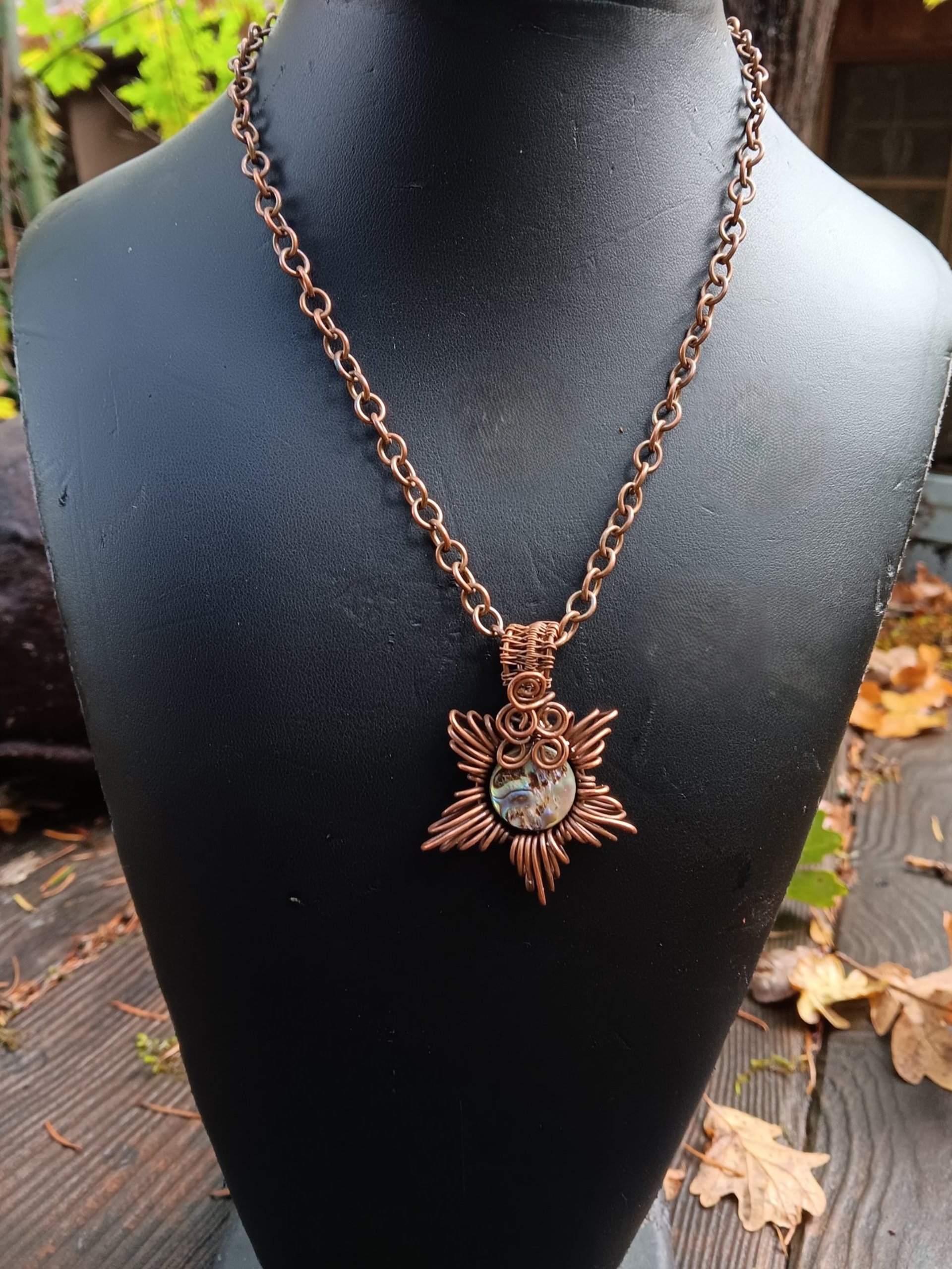 Copper corona pendant with brightly colored abalone shell center