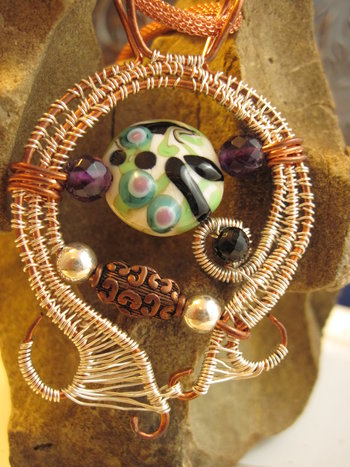 Mixed metal sterling and copper wire woven lampwork organic swirling pendant
