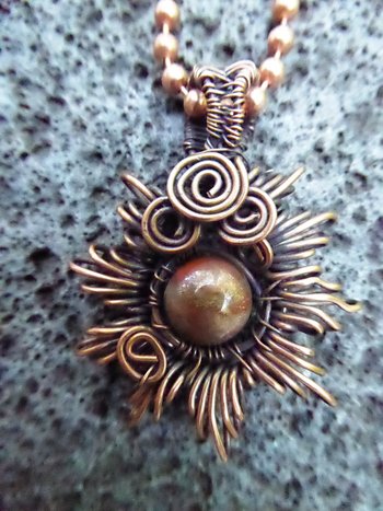 Copper corona pendant with multicolored stone center